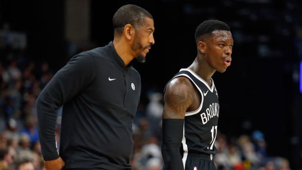 Brooklyn Nets head coach Kevin Ollie (left) talks with Brooklyn Nets guard Dennis Schroder (17)